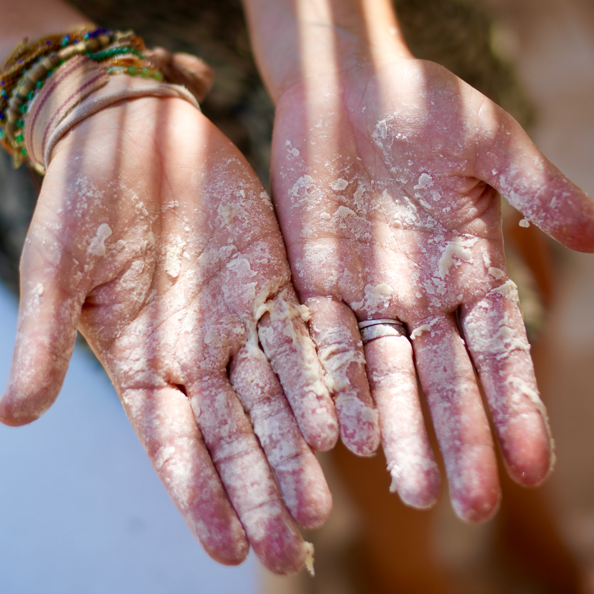 Flour-covered hands while making fresh pasta