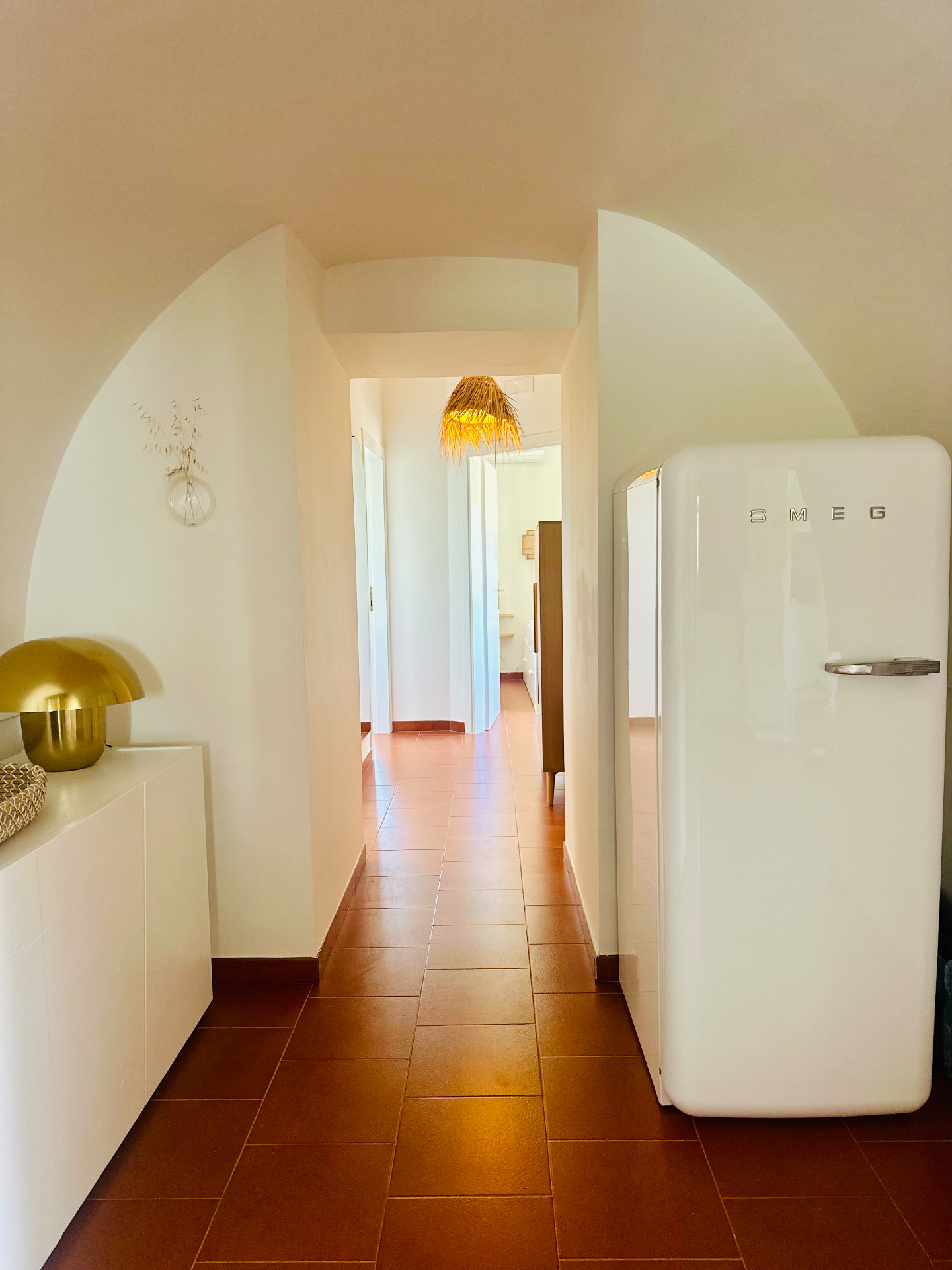 Arched interior hallway with the retro Smeg refrigerator