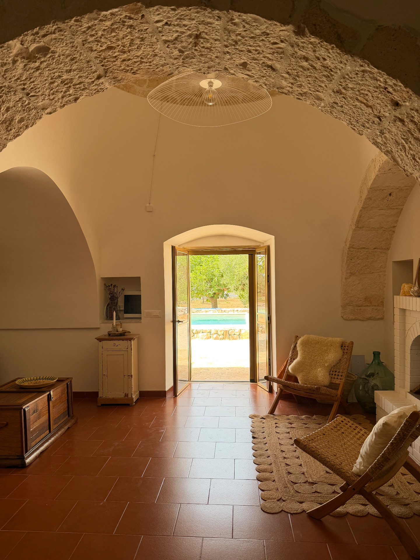 Trullo living room with open doors towards the private pool