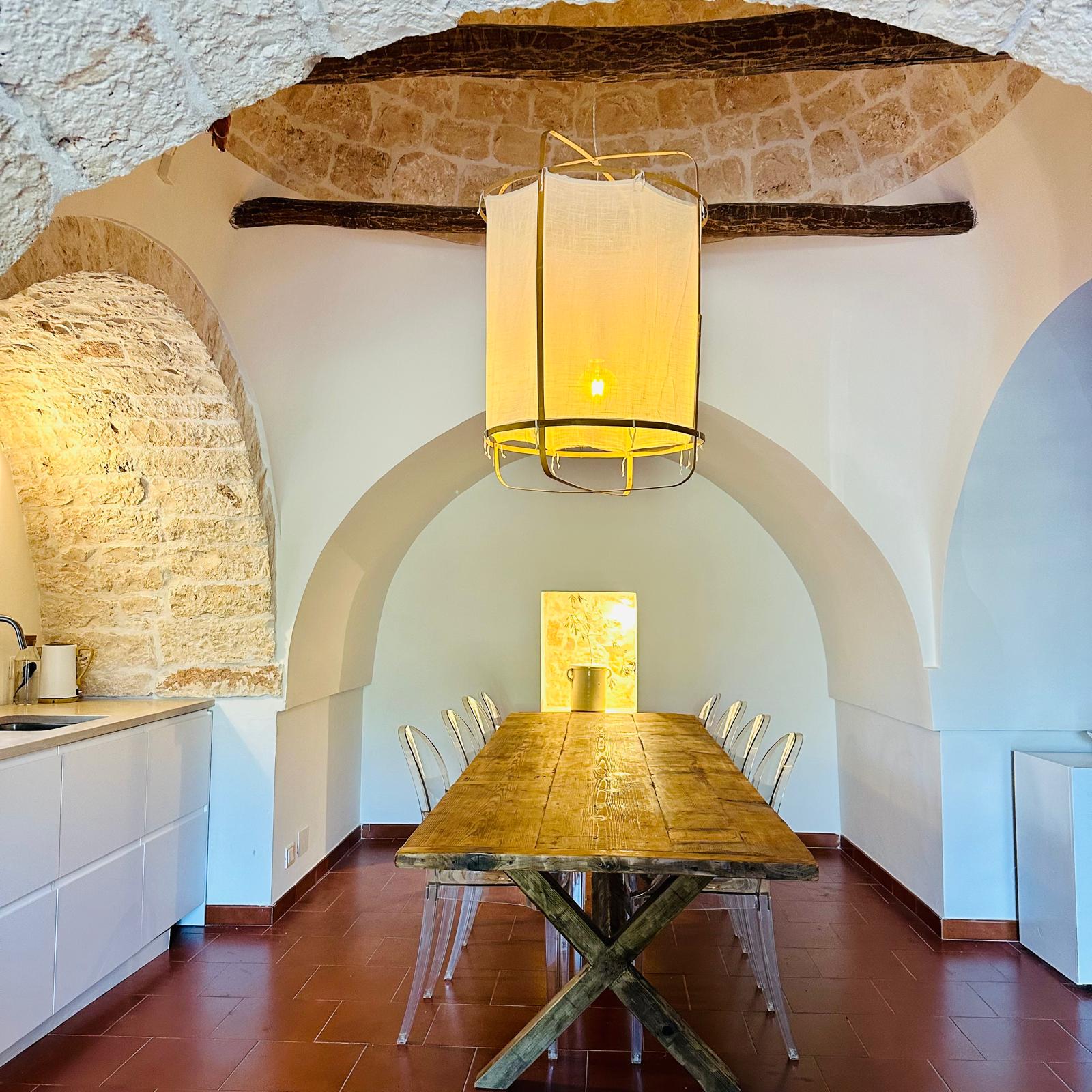 Dining room beneath the original stone arches of the trullo